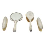 A Ladies Vanity Set, comprising mirror, hair brush, and two other smaller brushes, each silver