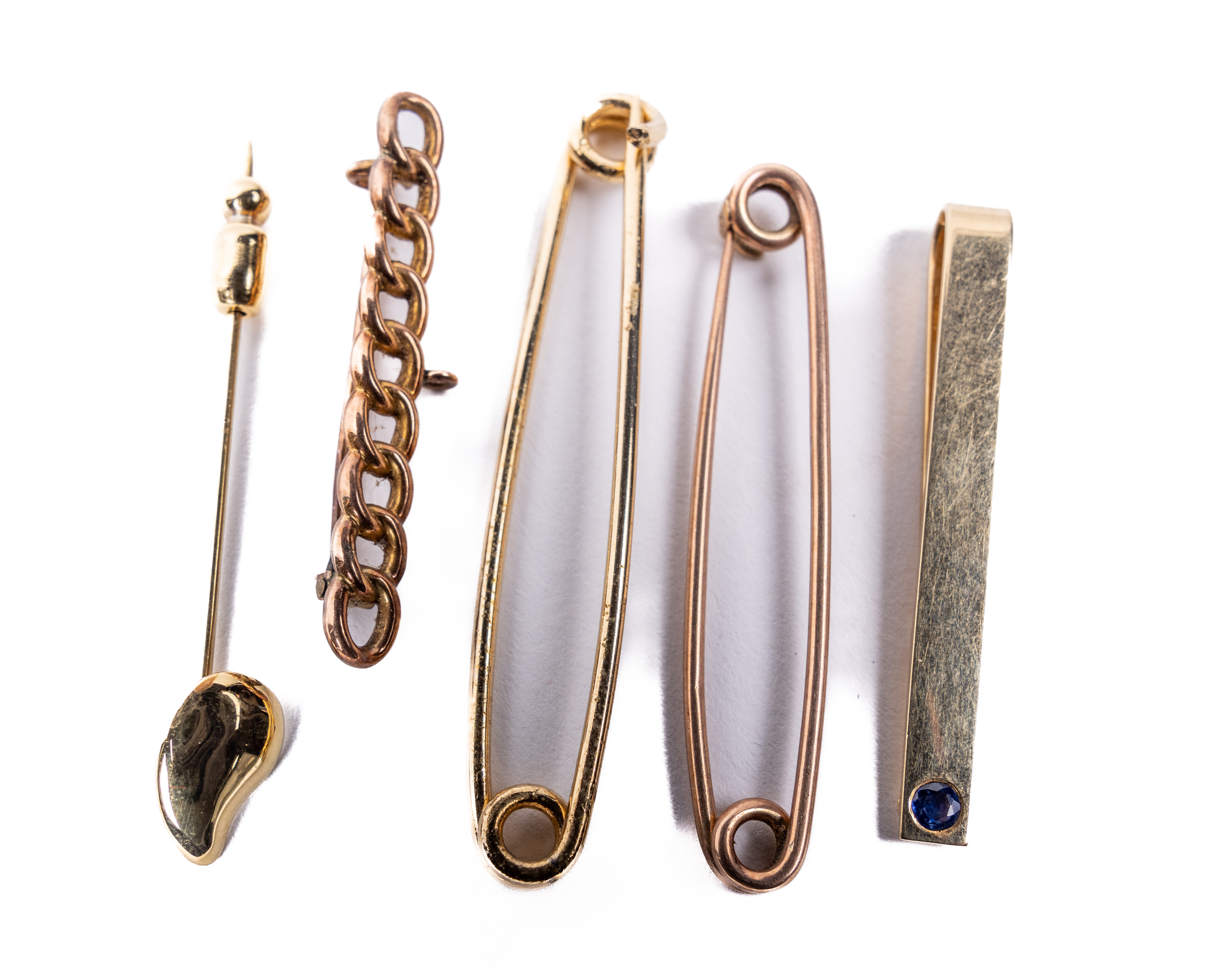 A 9ct gold link chain design Tie Pin, a 9ct gold Tiffany & Co. Tie Pin set with single sapphire; two