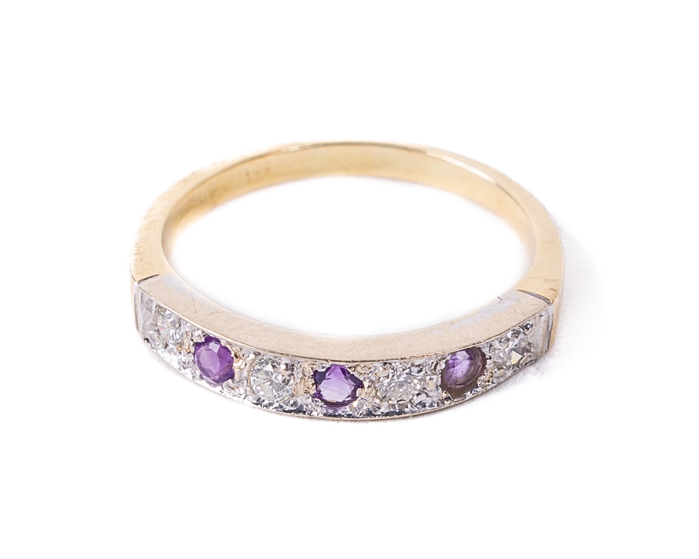 A Ladies 18ct gold Ring, set with three amethyst stones and four .06ct diamonds, size Q1/2,