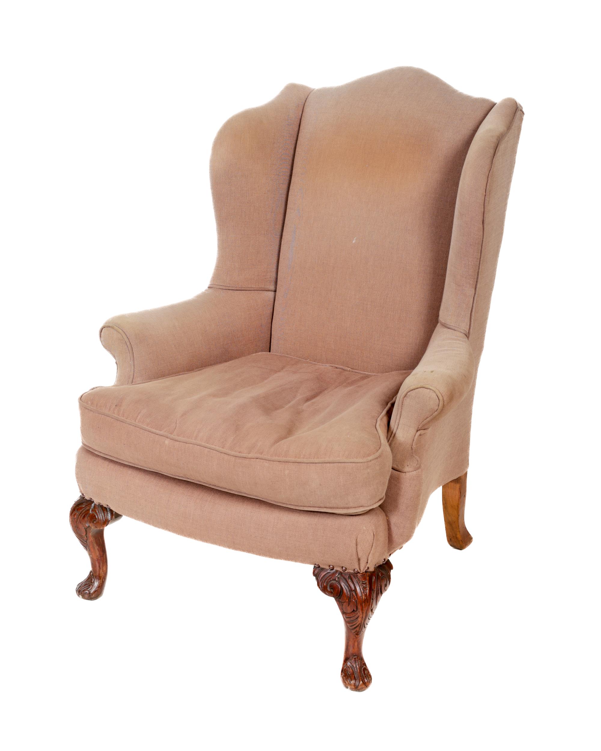A 19th Century mahogany framed wing back Armchair, covered in cream fabric, with loose cushion, on