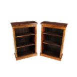 An attractive pair of Victorian walnut narrow Open Bookcases, the moulded top over plain frieze with