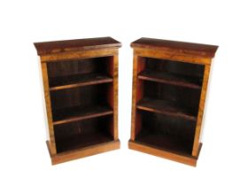 An attractive pair of Victorian walnut narrow Open Bookcases, the moulded top over plain frieze with