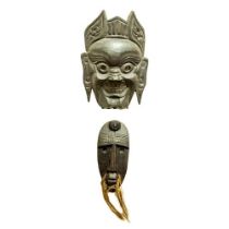 A good carved wooden African Tribal Mask, with hairy whiskers and oval face with copper inset