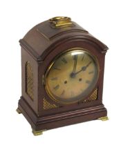 A late 19th Century mahogany Bracket or Mantle Clock, the arched top with brass carrying handle,