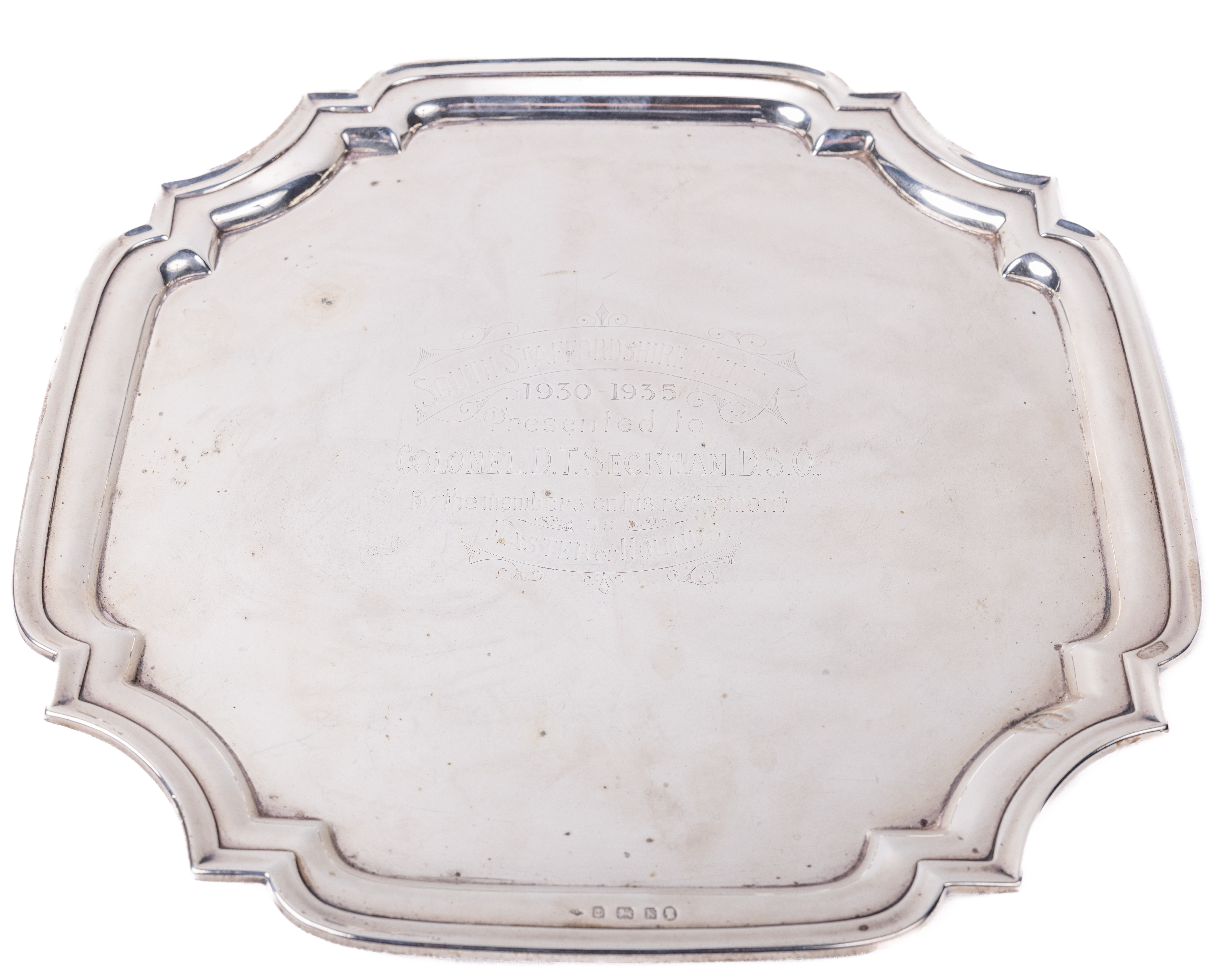 An Edwardian English silver Salver, of moulded and shaped form, the centre inscribed "South