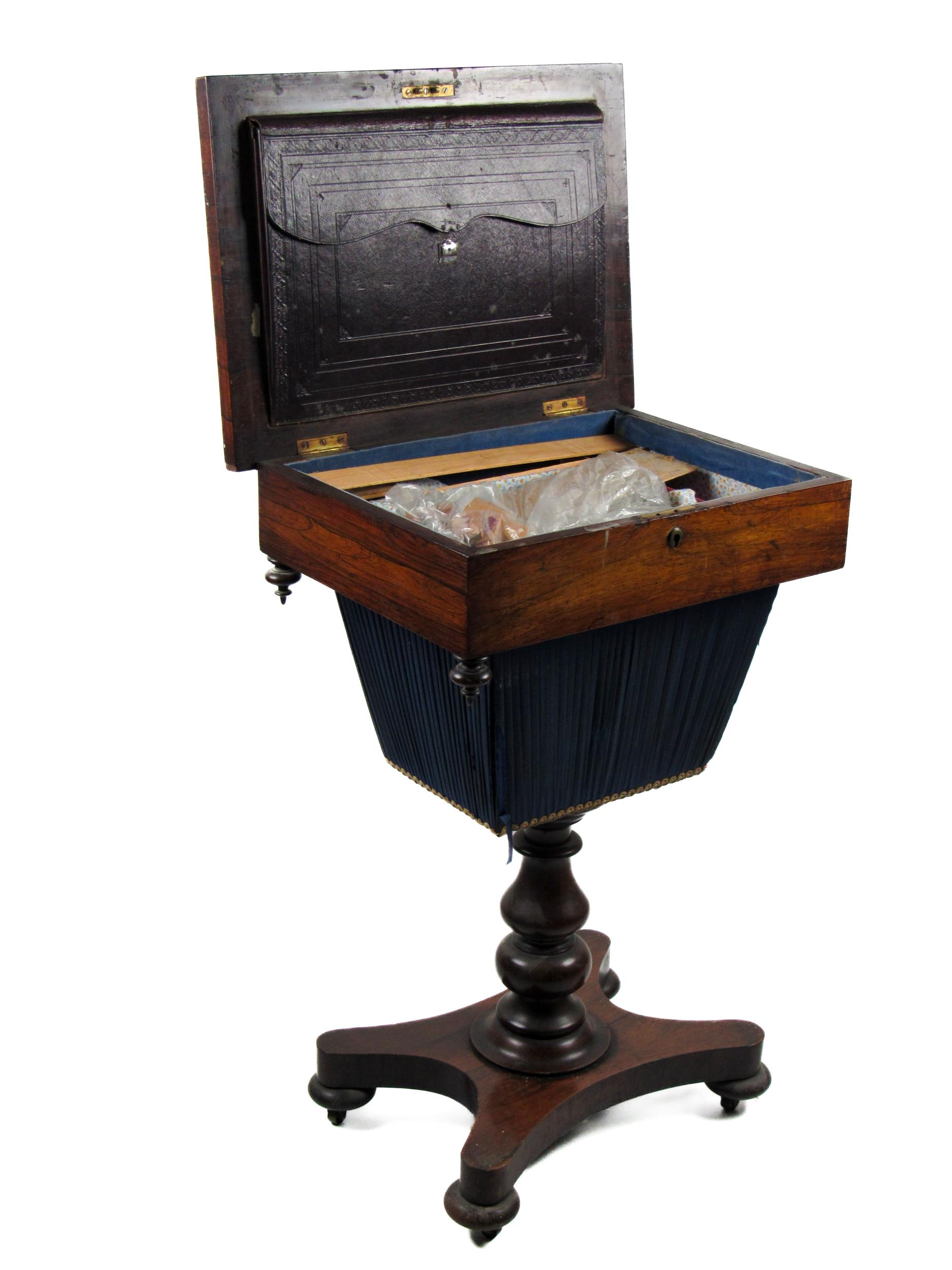 A Victorian rosewood Ladies Work Table, lift top with sunken container on a turned pillar support on