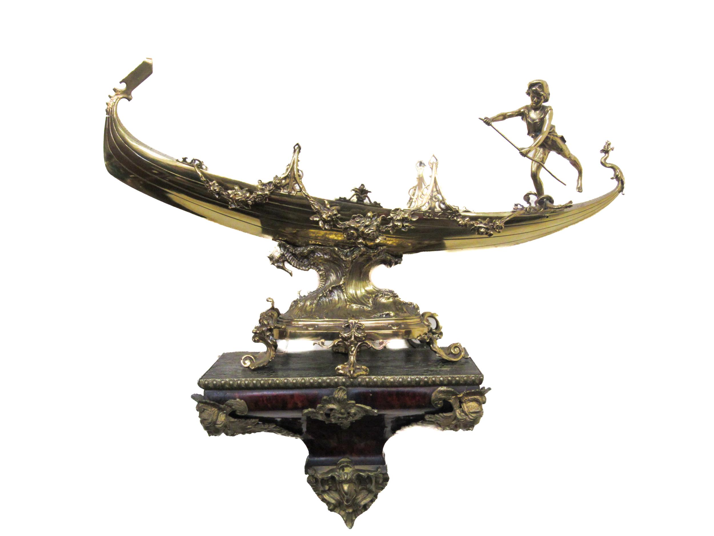 An attractive and ornate brass Model, of a Gondola and Gondolier, embellished with floral garlands