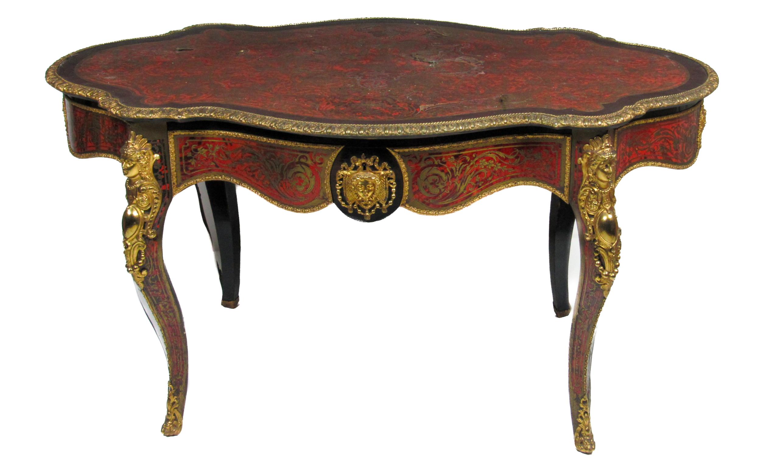 A 19th Century French ormolu mounted red boulle Table, the shaped oval top with cast egg n' dart