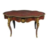 A 19th Century French ormolu mounted red boulle Table, the shaped oval top with cast egg n' dart