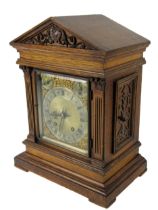 An oak cased 20th Century German made brass and steel dial Bracket Clock, the arched hood over