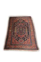 An attractive antique woolen oblong Carpet, the central navy ground with floral medallion, the