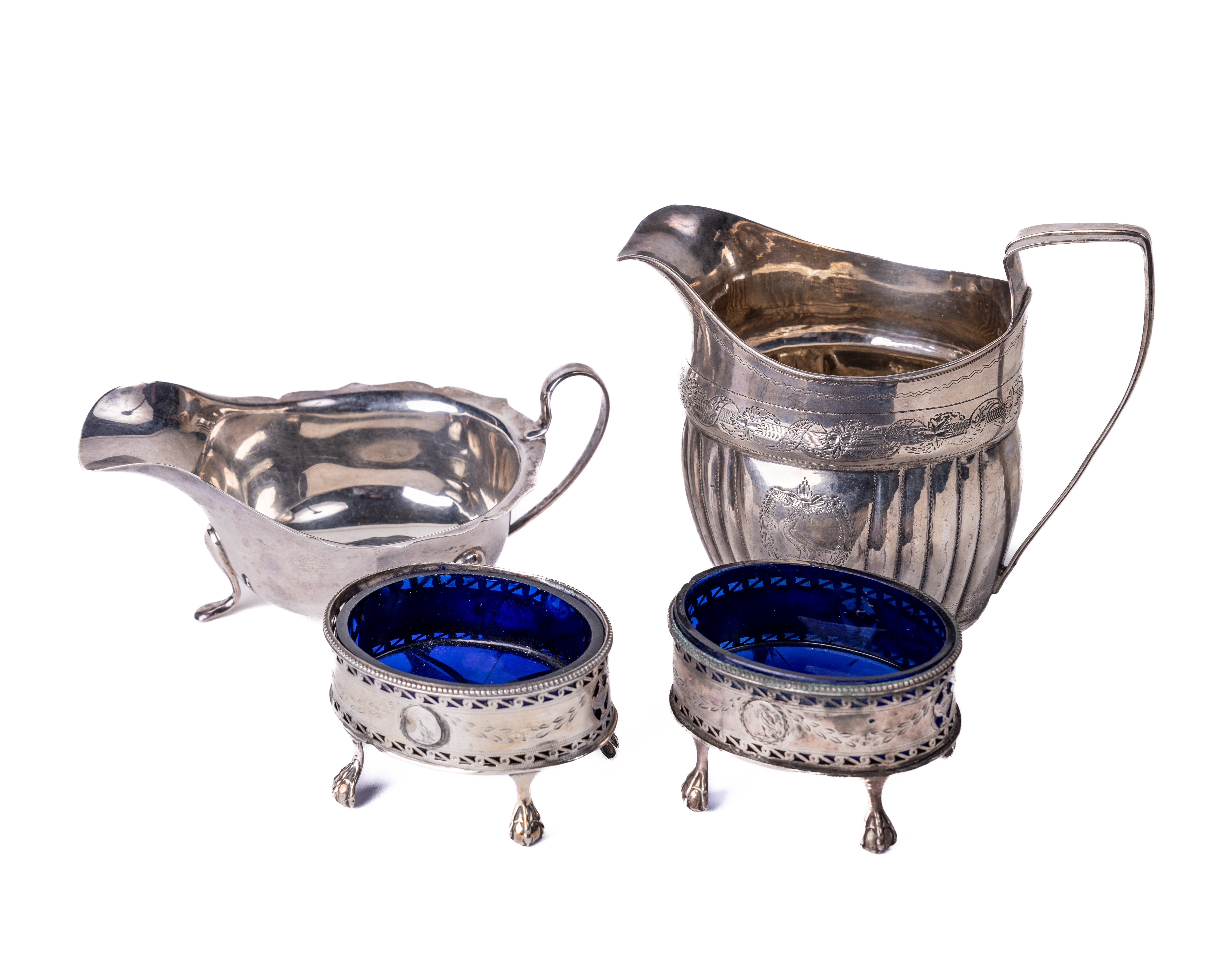 A pair of pierced and bright cut decorated silver Salts, with blue loose glass liners on ball n'