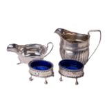 A pair of pierced and bright cut decorated silver Salts, with blue loose glass liners on ball n'