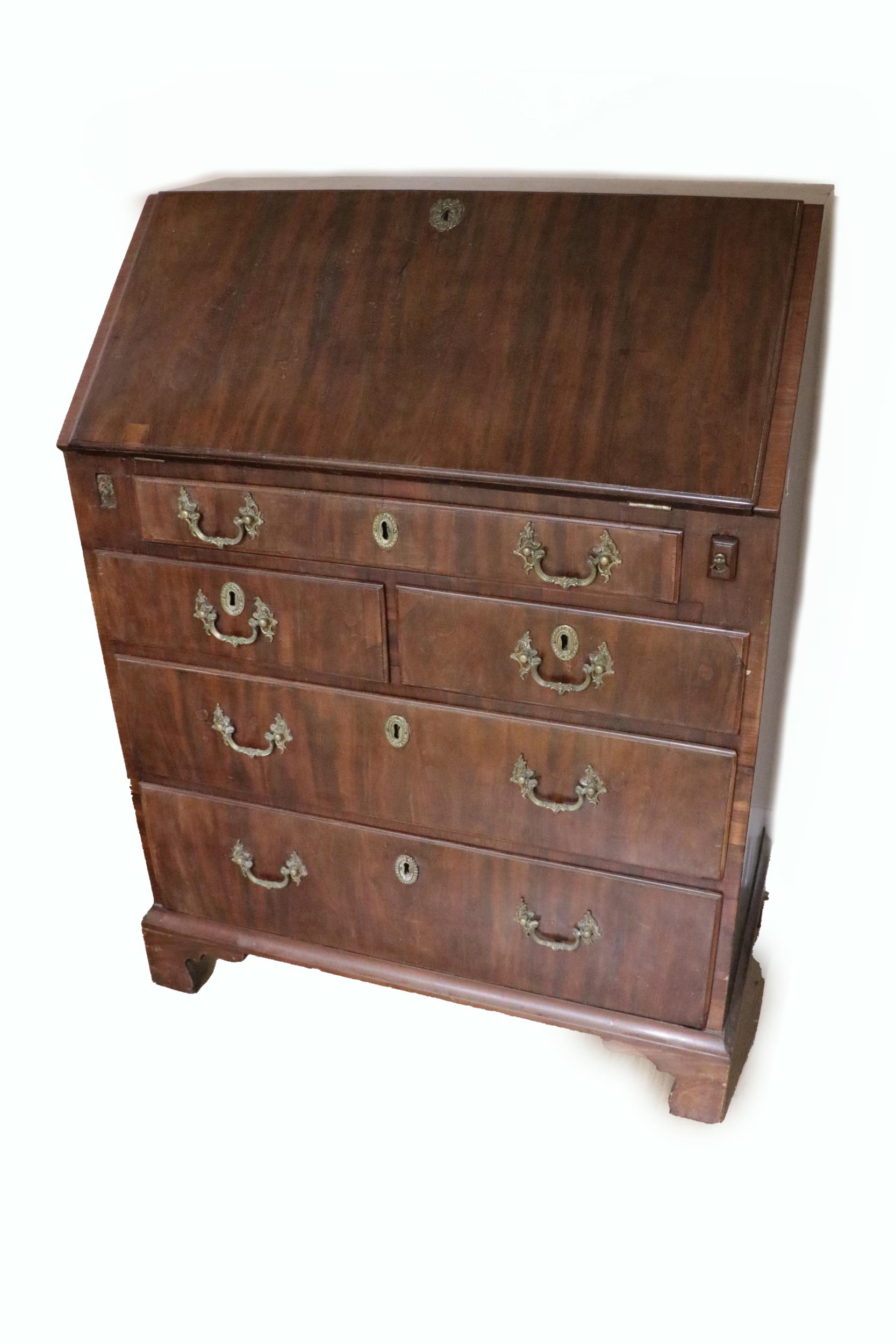 A Georgian period mahogany slope front Bureau, of small proportions, opening to reveal a fitted