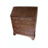 A Georgian period mahogany slope front Bureau, of small proportions, opening to reveal a fitted