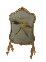 A 19th Century giltwood cartouche shaped Firescreen, with 'S' scroll and floral border, silk