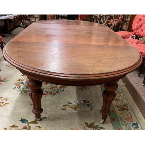A good Victorian mahogany telescopic Dining Table, with demi-lune ends and three leaves, raised on