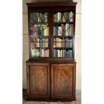 A George III period mahogany Bookcase, the moulded cornice above two astragal glazed doors on a base
