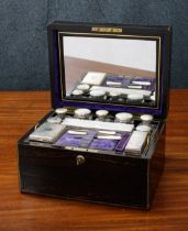 Victorian Coromandel travel dressing box, the hinged cover with inset brass plaque bearing a