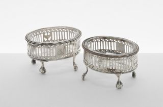 Pair of Georgian silver open salts, the pierced oval baskets raised on four claw and ball feet
