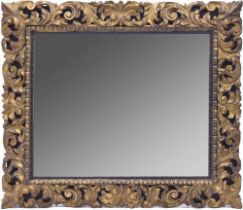 Decorative Florentine style giltwood wall mirror, with gilt foliate scrolling carved frame on a