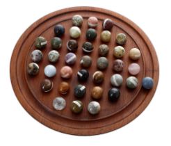 Turned hardwood marble solitaire board with labelled polished geological specimen marbles, board 10"