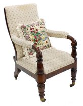 Victorian rosewood salon armchair, in floral upholstery, scroll and foliate carved arms over