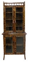 Good Victorian bamboo display cabinet, the upper section with two glazed doors enclosing a shelved