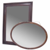 Mahogany cushion framed rectangular wall mirror, the bevelled glass within a carved motif border