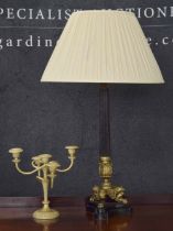 Decorative Empire style table lamp, on a trefoil base with gilt lion feet supports, 26" high