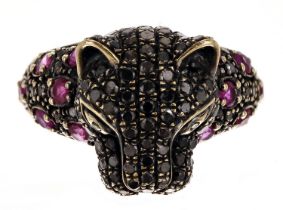 Unusual 18ct yellow gold wild cat design ring, set with rubies and black diamonds, width 15mm,