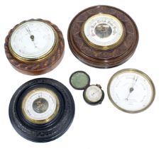 Oak circular wall barometer, the 5" dial signed Norie & Wilson, London, within a rope twist