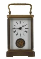 Unusual carriage clock timepiece with visible escapement positioned beneath the Roman numeral