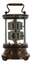 Silver plated ticket clock, within a cylindrical glazed case with fixed key wind beneath and