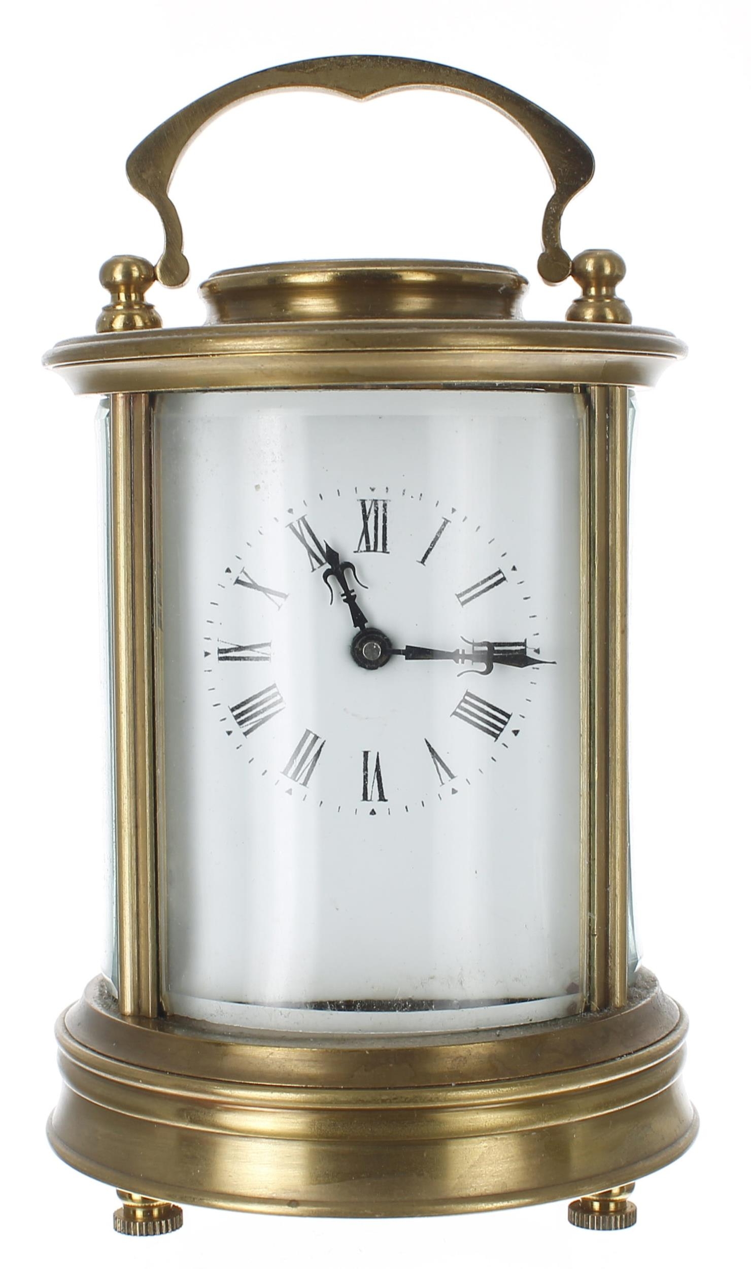 Carriage clock timepiece, within a circular bevelled glazed brass case, 6.75" high