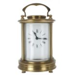 Carriage clock timepiece, within a circular bevelled glazed brass case, 6.75" high