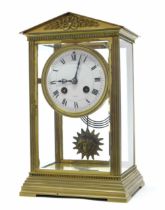 French brass four glass two train mantel clock striking on a gong, the 3.75" white dial within a
