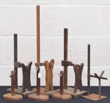 Three similar clockmakers wooden stands, tallest 24" high; also a metal clockmakers stand and
