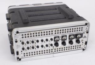 4U Rack flight case enclosing three Behringer rack units to include a Model T1952 Tube Compressor