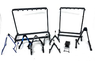 Good selection of various stands to include two folding rack guitar stands, speaker stands,