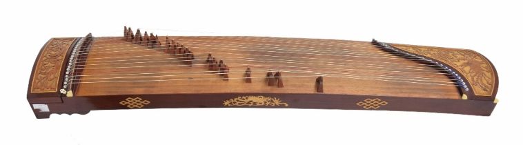 Modern Chinese long zither (raft), with twenty-one strings and foliate carved ends, 65" long