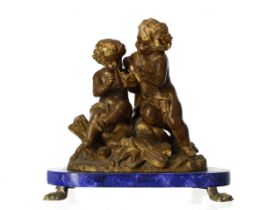 French 19th century ormolu classical figural group, modelled as two putti playing musical