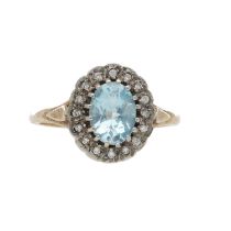 9ct yellow and white gold cluster ring, set with central oval blue topaz surrounded by halo of