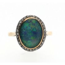 Attractive 18ct yellow gold oval triplet black opal and diamond ring, the border with round-cut