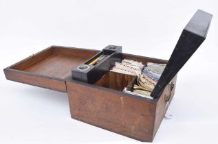 Old wooden stationery box, the hinged cover enclosing a slope further hinged with divided interior