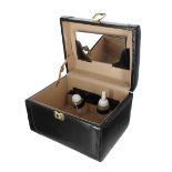 Franzen leather vanity case, the hinged cover with carry-handle, enclosing a plastic bottle and