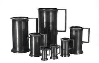 Set of seven graduated Continental pewter measures, including a litre, demi litre, double decilitre,