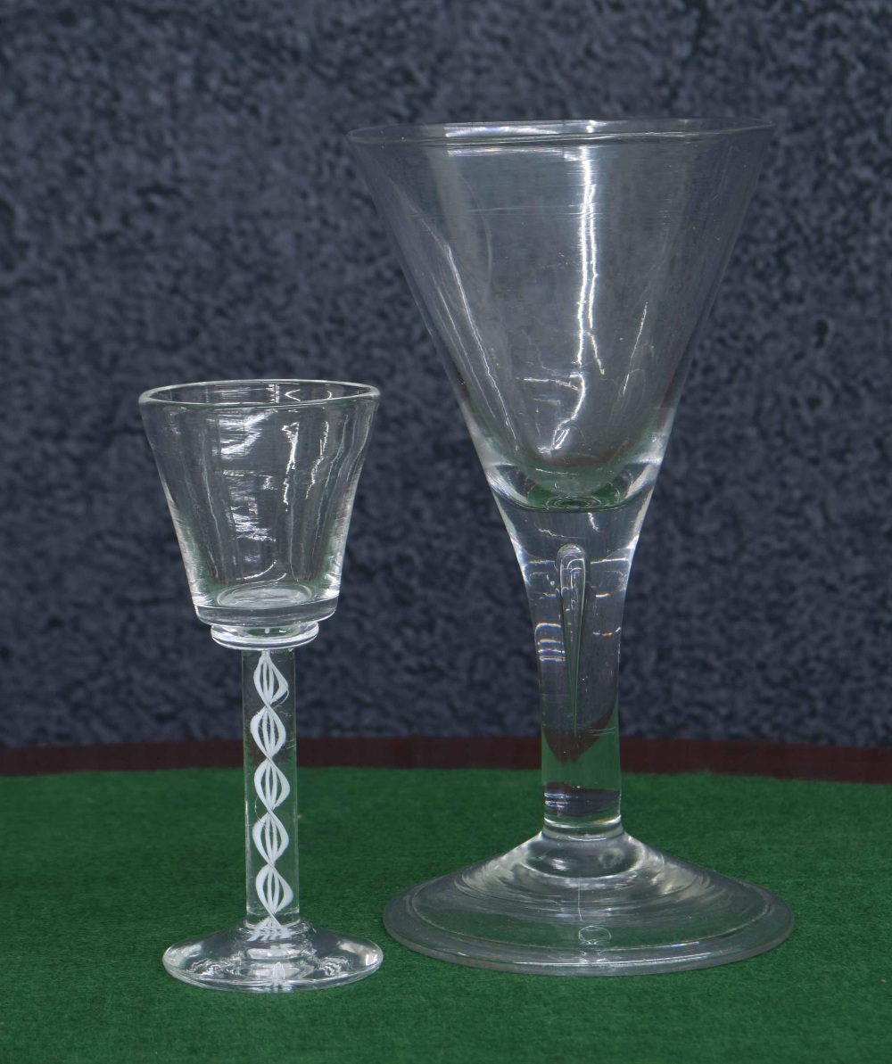 18th century wine goblet, with trumpet bowl over a plain stem with teardrop bubble inclusion, raised