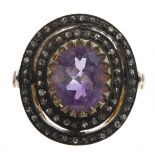 Stylish vintage style dress ring set with a central oval-cut amethyst and a double halo of rose-