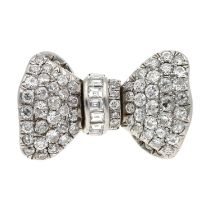 Impressive white metal diamond set bow design ring, pavé set with round and baguette-cut diamonds,